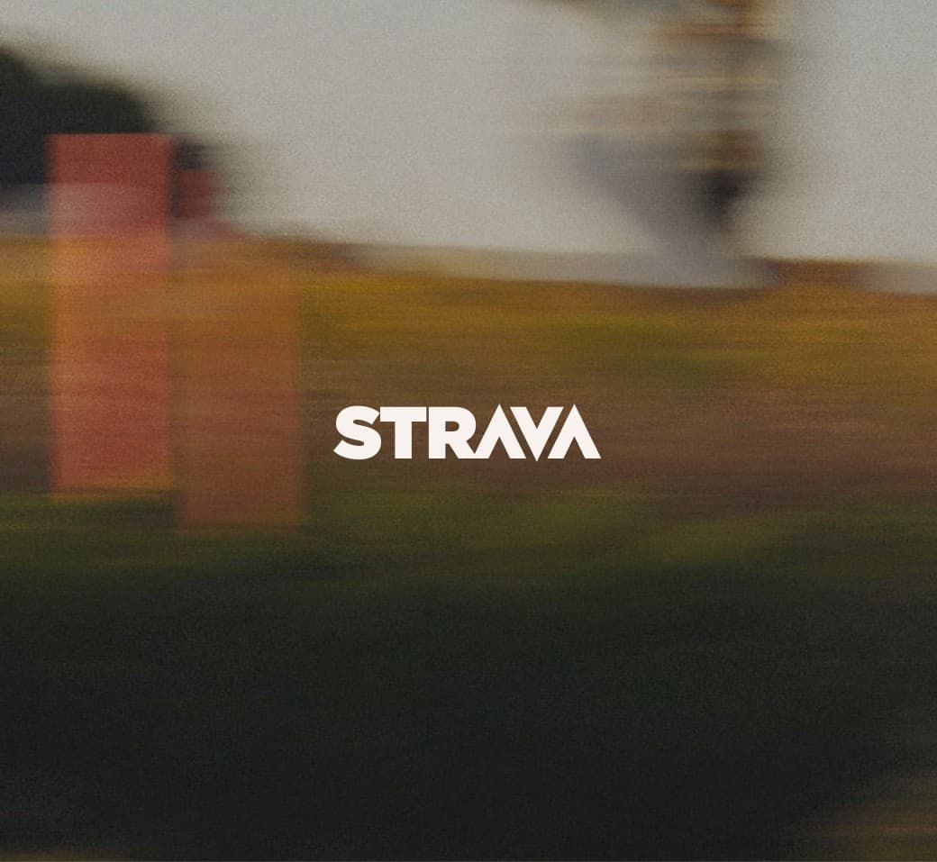 STRAVA logo over a blurred motion shot of a cyclist