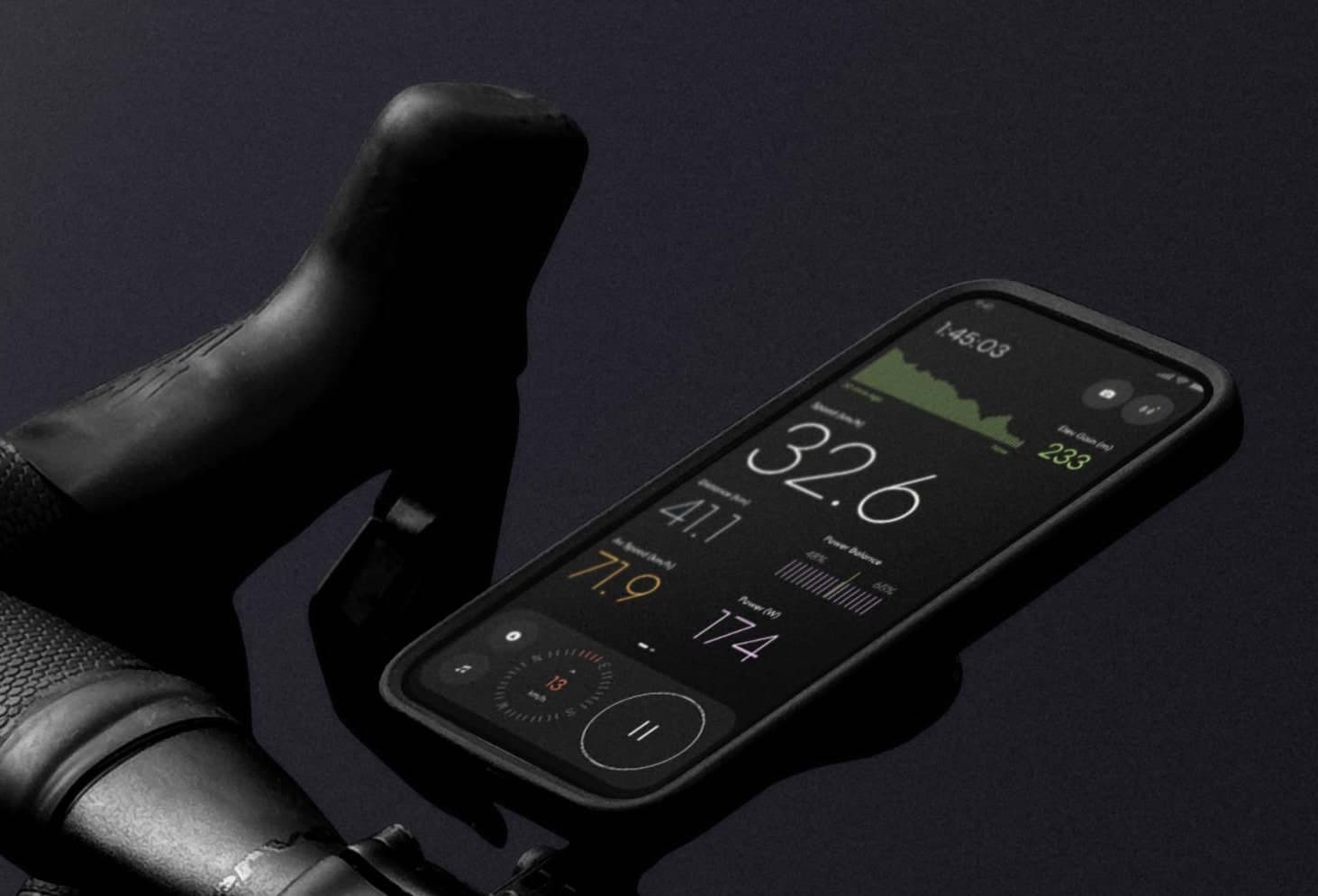 Close-up of an iPhone mounted on a road bike showing live power and speed metrics